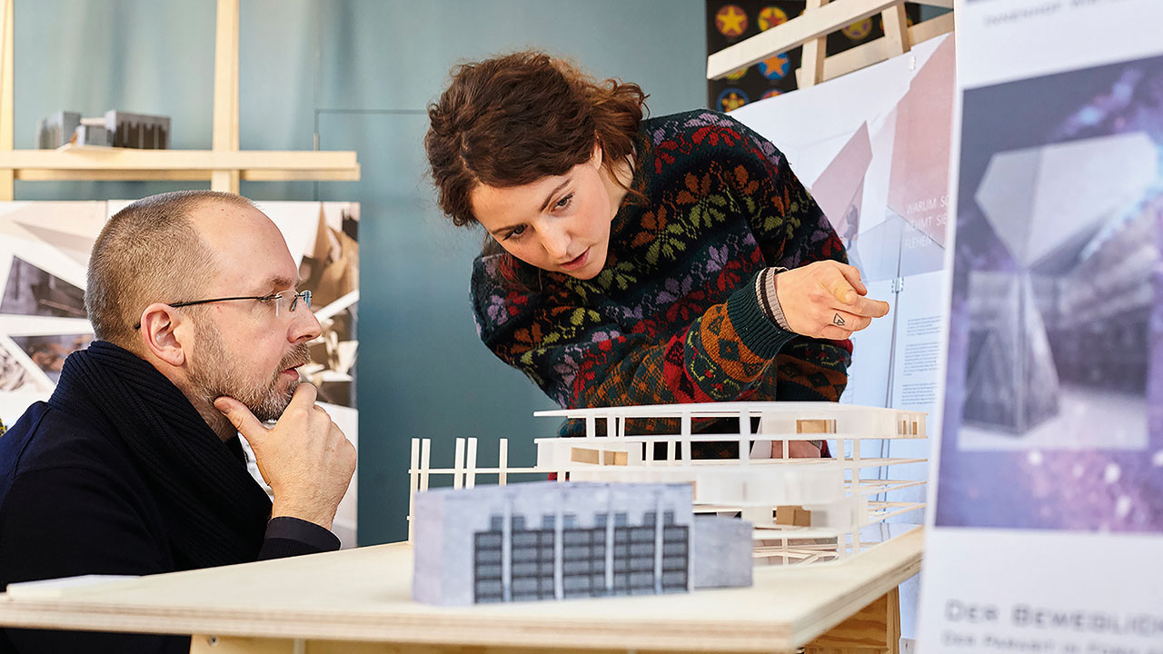 Studierende zeigen ein Modellgebäude