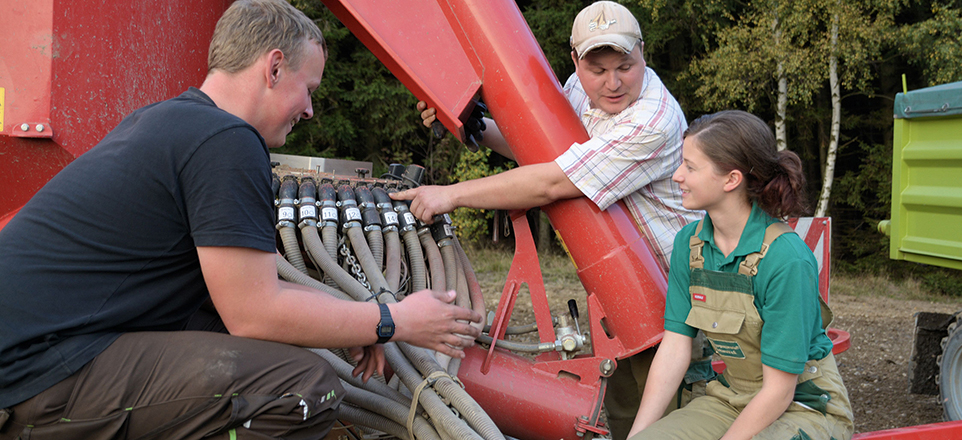 Ausbildungssituation in der Landwirtschaft. Die Szene vermittelt ein praxisnahes Lernen in einem landwirtschaftlichen Betrieb.